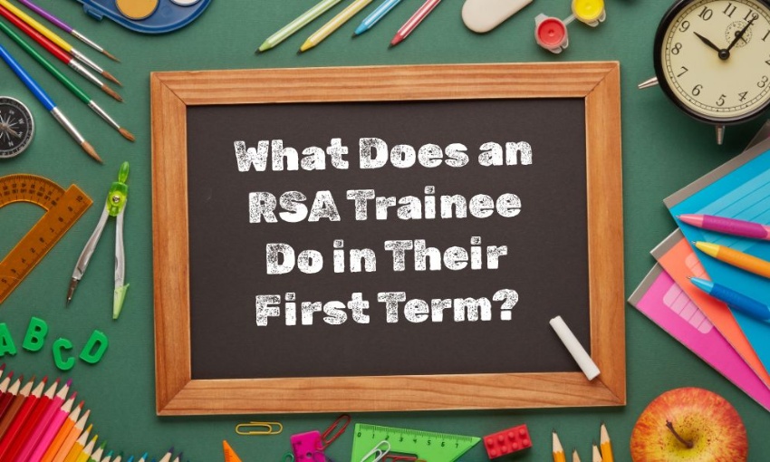 Image shows a small blackboard with the words what does an RSA trainee do in their first term? surrounded by school stationery and equipment